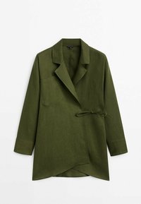Olive green, long-sleeve blazer with a tie waist, lapel collar, and a single chest pocket. Smooth, textured fabric with an asymmetrical hem.