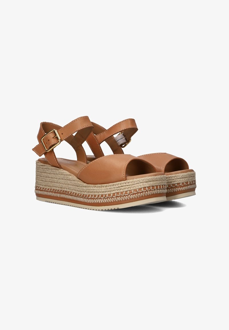 Brown leather platform sandals with crisscross straps, open toes, and jute-wrapped soles featuring a woven detail and buckle closure.