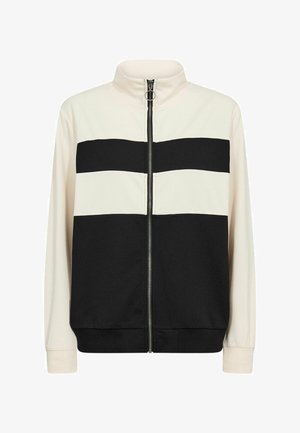Zwart- en crèmekleurig jack met rits, met horizontale strepen, een hoge kraag en geribde manchetten. Gemaakt van zachte, gladde stof.