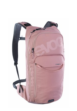 Pink backpack with textured fabric, zippered pockets, adjustable straps, and bold "evoc" logo. Features a sleek, modern design.