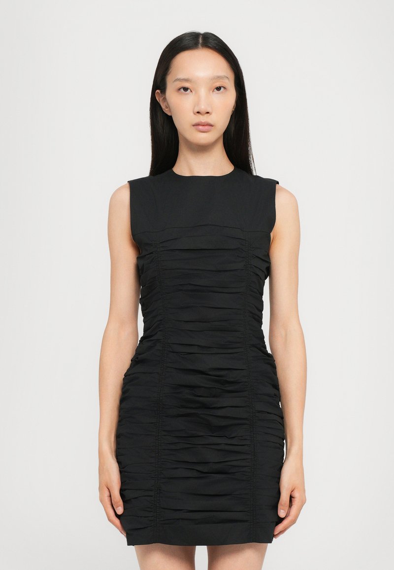 Black sleeveless dress with ruching detail throughout, fitted silhouette, smooth fabric, and crew neckline.