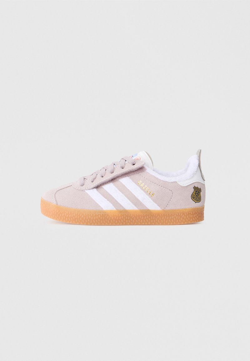 Light pink Adidas Gazelle sneaker with white stripes, gum sole, fluffy white lining, and a small police badge detail on the heel.