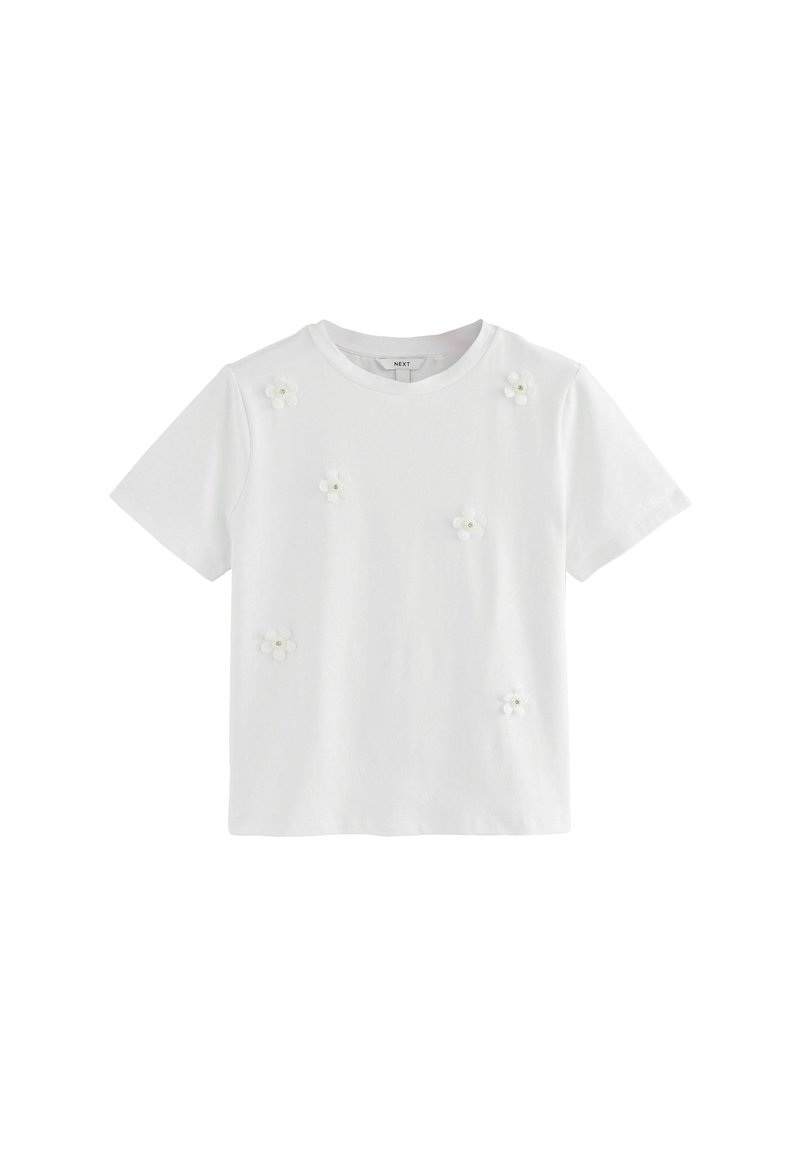 T-shirt blanc à manches courtes en coton doux, orné d'appliqués en forme de fleurs en tissu en grappes pour décorer le devant.