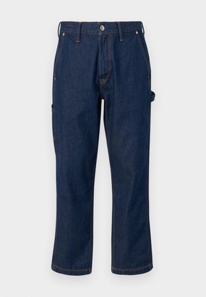 Dark blue denim pants with a straight-leg cut, featuring contrasting orange stitching and side pockets, secured with a metal button.