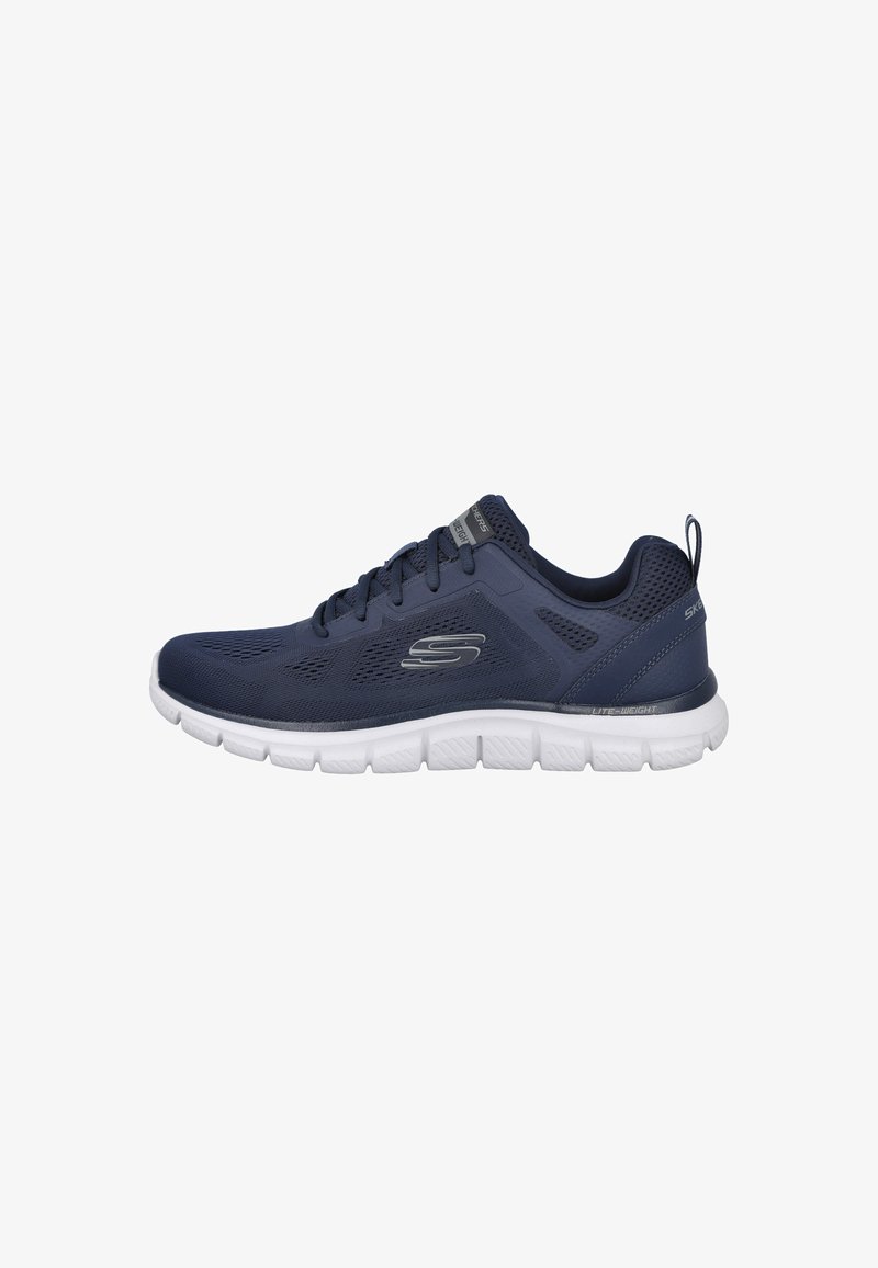 Zapatillas deportivas de malla en color azul marino con una suela blanca ligera, que presentan un upper texturizado, cierre de cordones y un lazo en el talón para facilitar su uso.