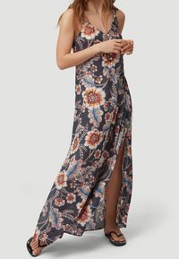 Długa, kwiatowa sukienka maxi w ciemnoszarym kolorze z żywymi kolorami i bocznymi rozcięciami. Lekka tkanina, z ramiączkami typu spaghetti i luźnym krojem.