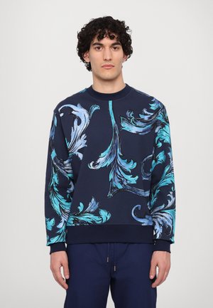 Navy sweatshirt with intricate blue floral pattern. Ribbed crewneck and cuffs. Soft fabric, relaxed fit, and long sleeves.