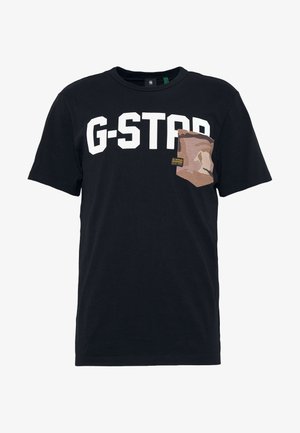 T-shirt noir à manches courtes avec un texte blanc audacieux "G-STAR" en travers de la poitrine et une poche poitrine camo marron sur le côté droit.