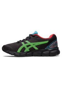 Zapatilla de correr negra con acentos verdes, parte superior de malla, cuello acolchado, detalles llamativos en rojo y azul, y suela de goma texturizada.