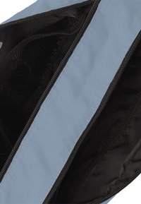 Blue textile bag with a smooth exterior, zip closure, and black nylon interior. Features mesh pocket for organization.