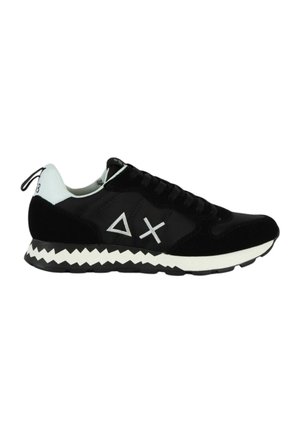 Black sneakers made of textile and suede, featuring white accents, geometric designs, and a zigzag-patterned sole.