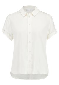 Blouse blanche à manches courtes avec boutons, à poignets retroussés et col pointu, présentée sur un fond uni.