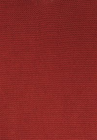 Red knitted fabric with a textured pattern, featuring small uniform stitches throughout, creating a dense and even appearance.