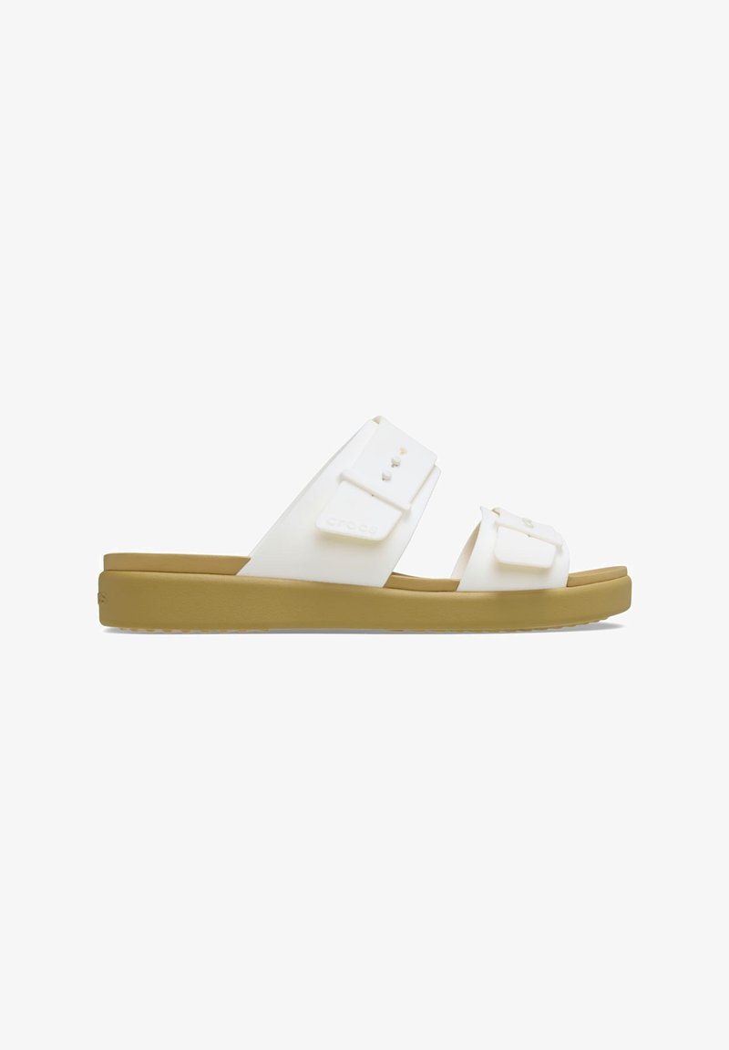 White slide sandals with two adjustable straps, made of soft material. Features a thick beige sole with traction detailing.