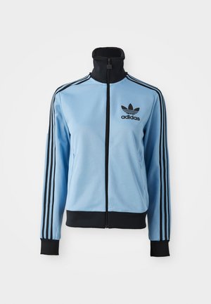 Light blue Adidas track jacket with black collar, cuffs, hem, three black stripes on sleeves, and Adidas logo on left chest.