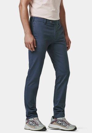 Navy blue slim-fit chinos with a smooth texture, featuring a button closure and side pockets, paired with gray sneakers.