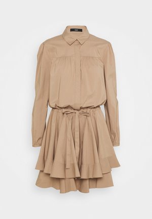 Beige shirt dress with a collar, puffed sleeves, and front pleats. Features a belted waist and layered ruffle hem. Made from lightweight fabric.