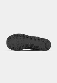 Black sneaker sole with deep treads, rubber material, and textured surface. Features a slight curve at the heel and a logo imprint.