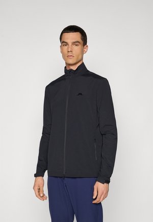 Black zip-up jacket made of lightweight material, featuring a stand-up collar, side pockets, and a small logo on the chest.