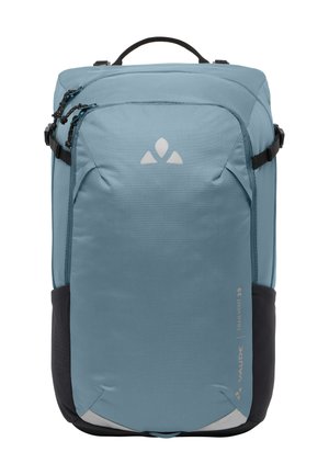 Blauwe rugzak met een gladde textuur, driehoekig logo, meerdere compartimenten en zwarte accenten. Ontworpen voor functionaliteit en reizen.