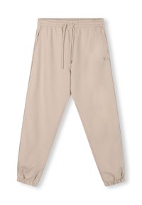 Beige sweatpants met een elastische tailleband, verstelbare trekkoord en taps toelopende broekspijpen. Voorzien van een klein reliëf logo aan de zijkant.