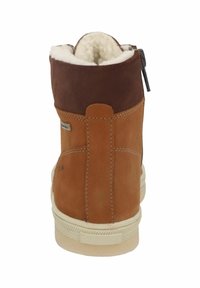 Brown leather ankle boot with a soft fur interior, zipper closure, beige sole, and contrasting brown upper section. Stitched detailing visible.