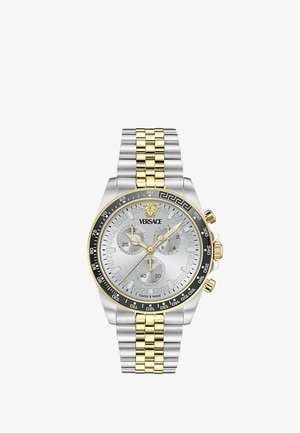 Versace kétszínű ezüst és arany kronográf óra három segédszámlappal, Medúza logóval 12 óránál, fekete lünettával tachiméter jelzésekkel.