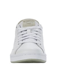 White leather sneakers with silver-glitter laces, a grey suede accent, and a textured rubber sole. Features logo on tongue.