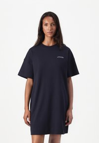 Marineblaues, oversized T-Shirt-Kleid aus Baumwolle mit kurzen Ärmeln, Rundhalsausschnitt und kleinem Logo auf der Vorderseite. Weicher Stoff.