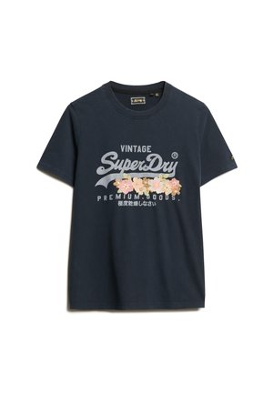 T-shirt in cotone blu navy con un grande logo stampato in bianco e ricamo floreale. Maniche corte e scollo rotondo.