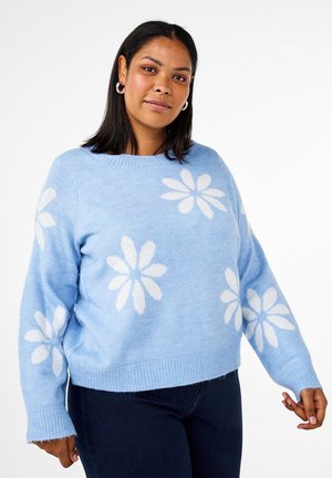 Hellblaues Sweater mit weißen Gänseblümchenmustern. Ausgestattet mit einem runden Halsausschnitt und gerippten Bündchen. Weiche Textur und lockere Passform, mit einem verkürzten Saum.