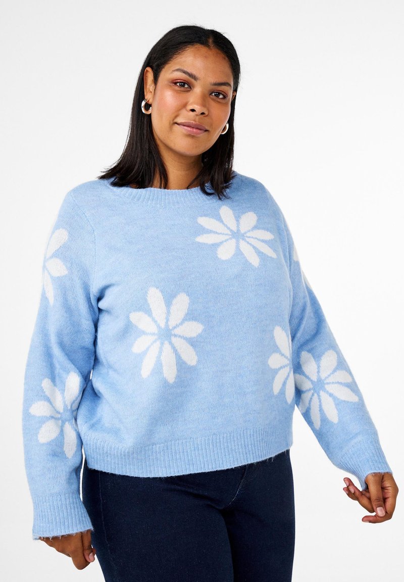Hellblaues Sweater mit weißen Gänseblümchenmustern. Ausgestattet mit einem runden Halsausschnitt und gerippten Bündchen. Weiche Textur und lockere Passform, mit einem verkürzten Saum.