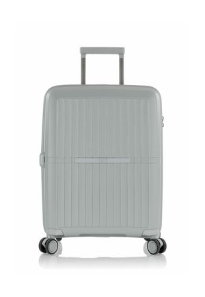 Gray hard-shell suitcase with vertical grooves, retractable handle, and four spinner wheels for ease of movement. Sleek design and textured surface.