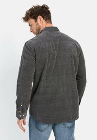 Charcoal gray long-sleeve shirt with a button-down collar, textured fabric, and contrasting buttons on the cuffs. Back view.