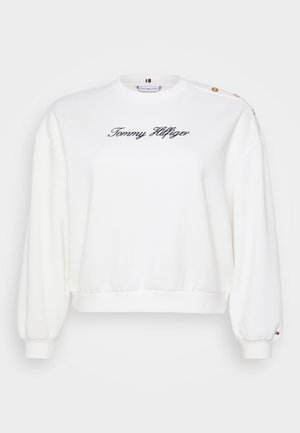 Hvit hettegenser med rund hals, med ribbestrikkede mansjetter og kant. "Tommy Hilfiger" brodert i svart, med gullknappe-detaler på skuldrene.