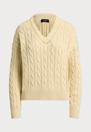 Pull en tricot crème avec un col en V et des poignets côtelés. Design court avec des motifs texturés sur toute sa surface et une coupe ajustée.