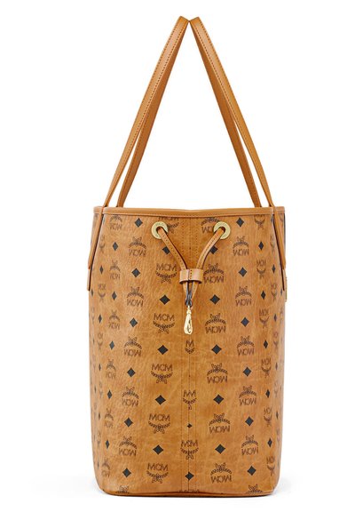 Tan leren emmer tas met zwarte MCM-logo's, ruitpatroon, dubbele schouderbanden en een leren trekkoordsluiting aan de voorkant met gouden hardware.