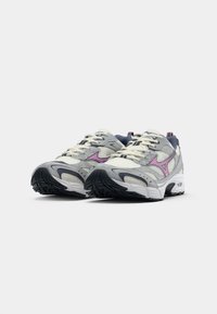 Lightgrey athletic shoes with purple accents, mesh and synthetic materials, textured soles, and rounded toe design. Laces in cream color.