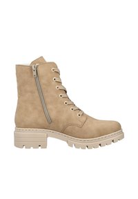 Beige lace-up ankle boot made of suede, featuring a side zipper, textured surface, and a chunky beige sole with traction details.
