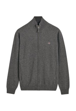 Grijze zip-up cardigan van zachte brei-stof. Heeft een hoge kraag, twee zijzakken en een subtiele logo op de borst.