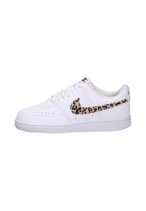 White leather sneaker with perforations, featuring a leopard print swoosh and a textured white sole. Laced with white shoelaces.