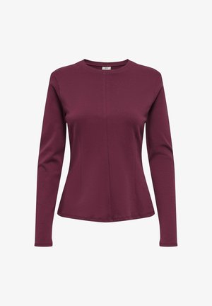 Pehmeast kangast maroon värvi pika varrukaga särk, millel on ümmargune kaelus ja keha lähedale lõigatud talje, sisaldades peeneid külgõmblusi, et luua kohandatud välimus.