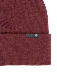 Burgundy knit beanie featuring a folded cuff and a small black label with logo. The texture is soft and slightly coarse.