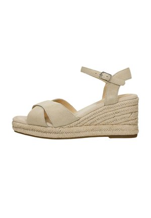 Sandale compensée beige avec plateforme en corde tressée, brides croisées en daim et fermeture à boucle réglable à la cheville.