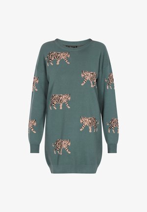 Roheline kootud sviiter, millel on korduv tiigeri muster roosa ja musta värviga. Sügava kaelusega ja vabalt istuvad varrukad.