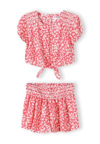 Set in cotone composto da top rosa e pantaloni corti coordinati con vita smock, entrambi decorati con una fantasia a spruzzi bianchi.