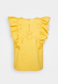 Gul ärmlös blus med volanger och spetsdetaljer på axlarna samt dekorativ broderad utskärning på framsidan.