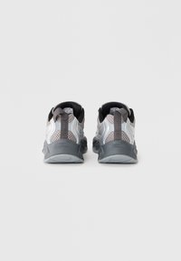 Gray and silver athletic shoes with a mesh upper, padded collar, and textured sole. Features a reflective accent and a pull tab on the heel.