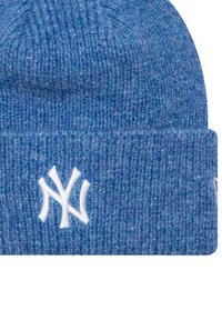 Bonnet en tricot bleu fabriqué en laine douce et texturée, avec un revers replié et un logo brodé blanc à l'avant.