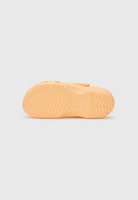 Orange rubber shoe sole with textured grip pattern and visible brand markings, including size impressions. Flat design with rounded edges.